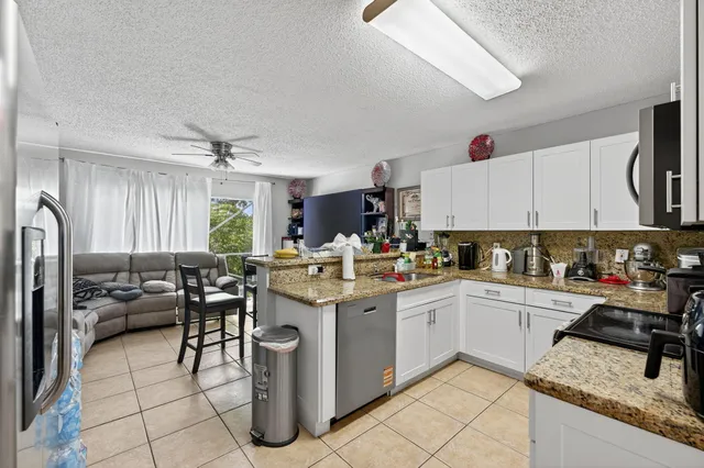 a kitchen with a sink counter top space appliances and cabinets