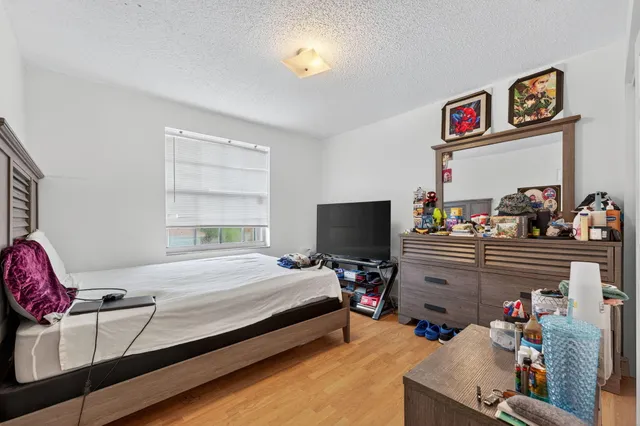 a bedroom with a bed and a flat screen tv