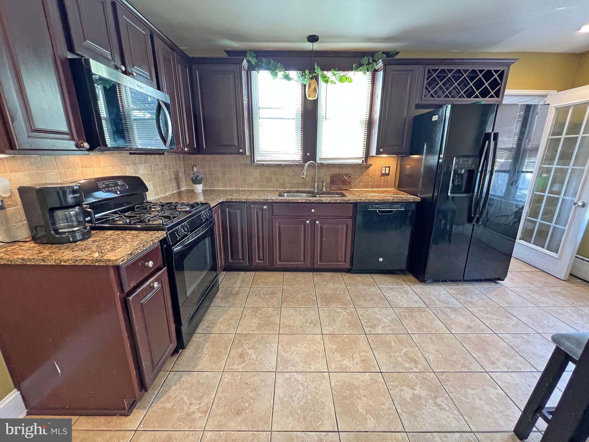 4129 Garrett Road Drexel Hill, PA 19026 - Photo 2 of 34 Kitchen with granite counters,backsplash,wine rack