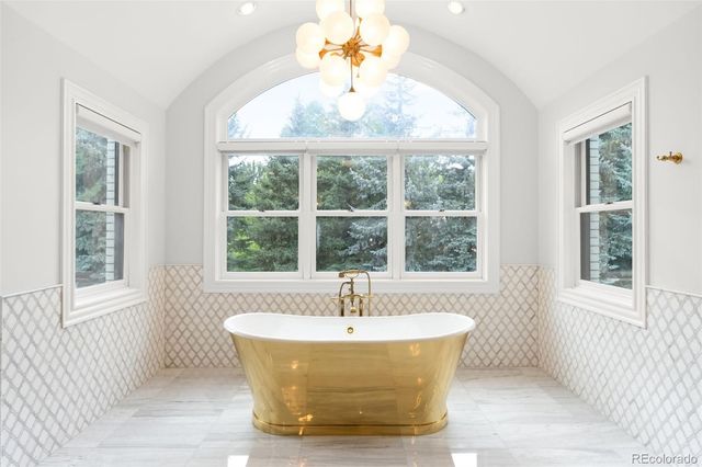 a white bath tub sitting next to a window