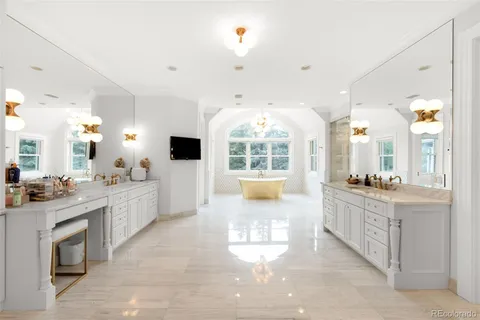 a large white kitchen with a large window