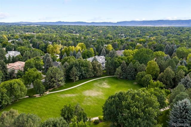 a view of a garden with a building in the background