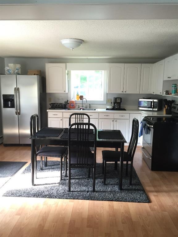 46 Village Road Stetson, ME 04488 - Photo 2 of 11 Lovely kitchen with light streaming...