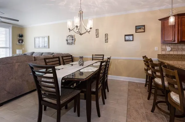 a view of a dining room with furniture and chandelier