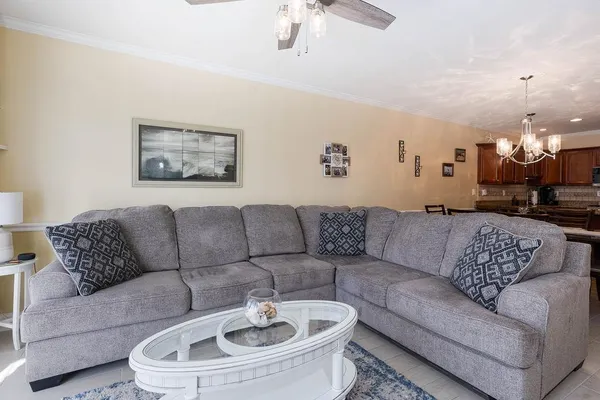 a living room with furniture a couch and a chandelier