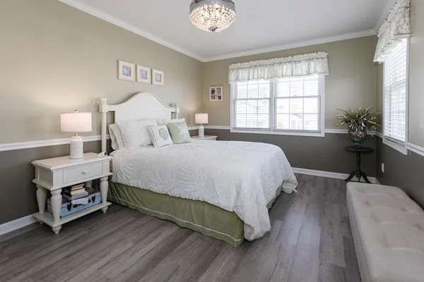 a bedroom with a bed and a chandelier