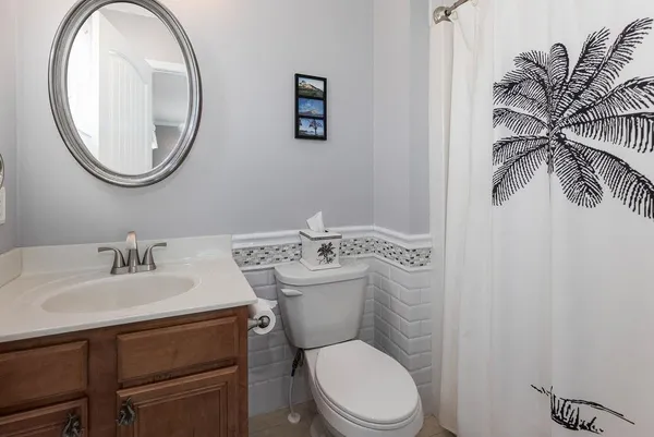 a bathroom with a toilet a sink and a mirror