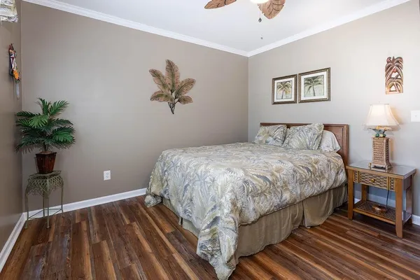 a bedroom with a bed and a potted plant