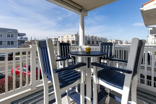 a view of a chairs and table in the balcony
