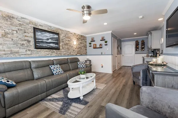 a living room with furniture and a chandelier