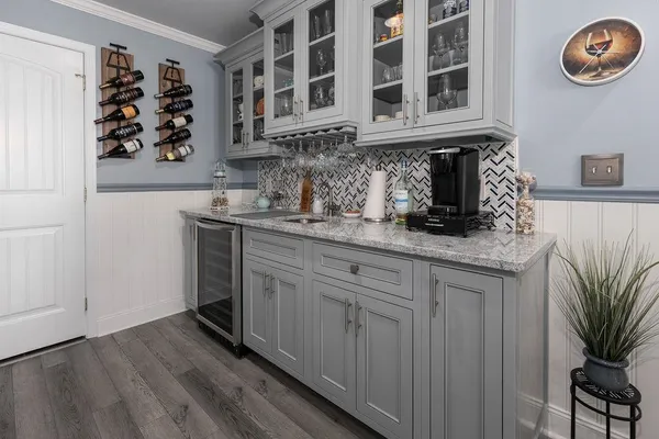 a kitchen with stainless steel appliances granite countertop a sink a stove and cabinets