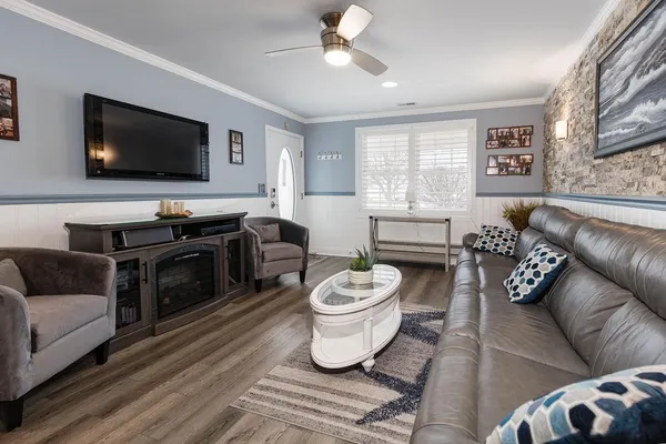 a living room with furniture and a flat screen tv