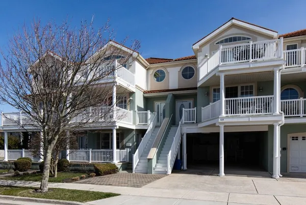 a front view of a building with a garden