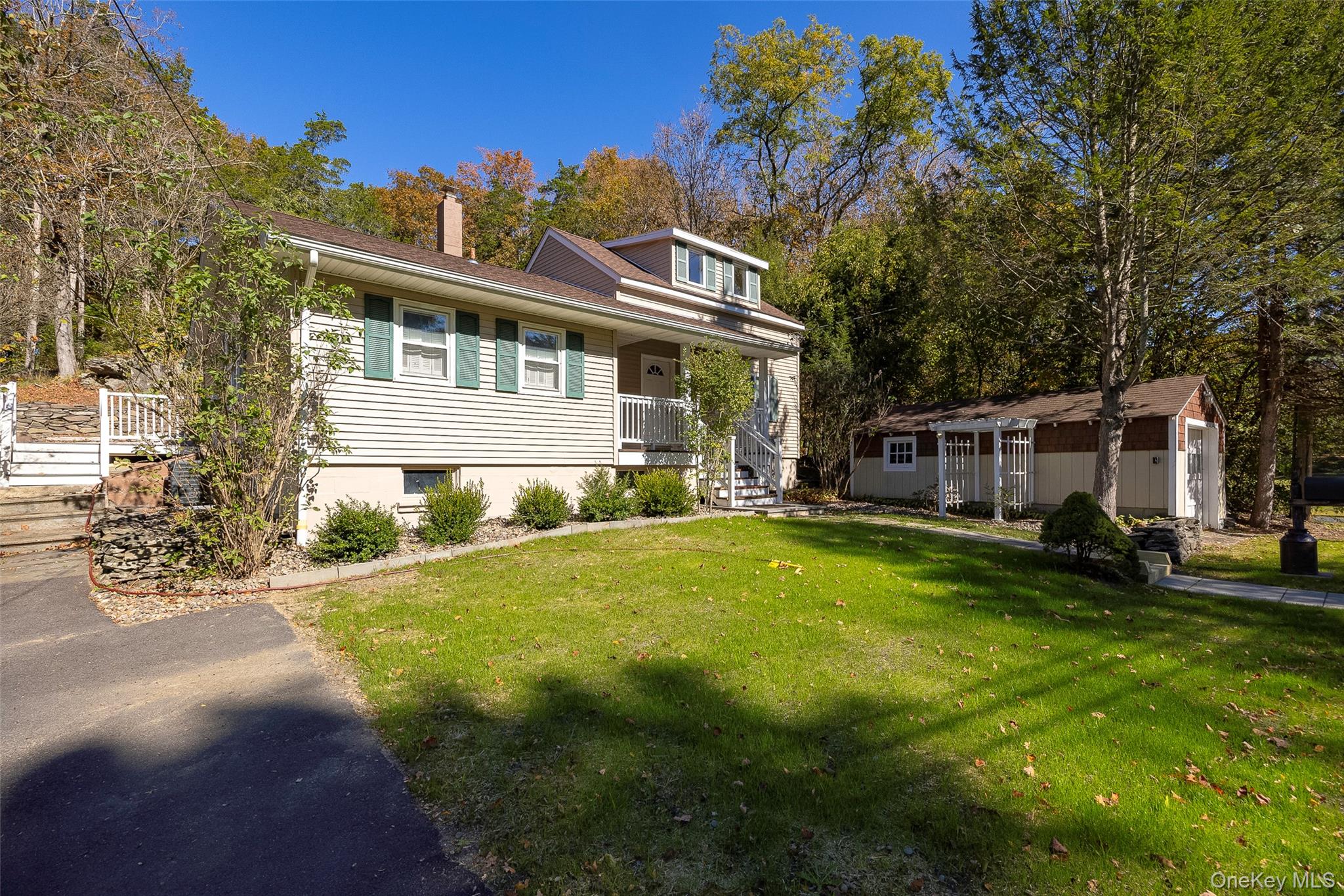 2 Haggerty Hill Road Rhinebeck, NY 12572 - Photo 4 of 47 Bungalow-style house featuring a front yard, an outdoor structure, a chimney, and view of wooded area