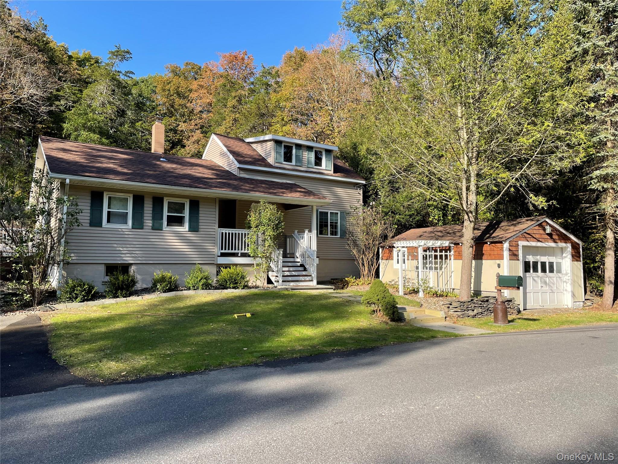 2 Haggerty Hill Road Rhinebeck, NY 12572 - Photo 46 of 47 View of front facade featuring an outdoor structure, a front yard, covered porch, a detached garage, and a chimney