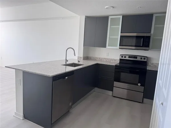 a kitchen with a sink and stainless steel appliances