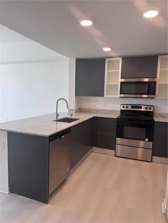 a kitchen with appliances a sink and a stove