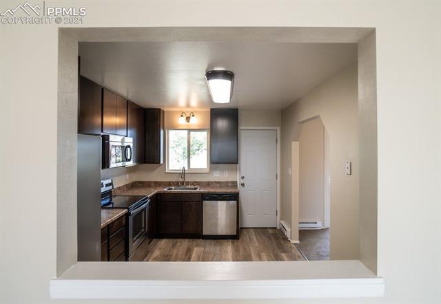 1315 Slocum Road Colorado Springs, CO 80930 - Photo 6 of 37 Kitchen w/ Walkout to Back Deck