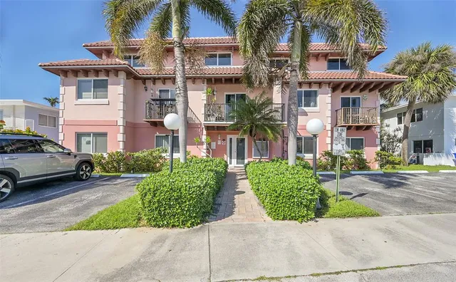a view of multiple houses with a yard and plants