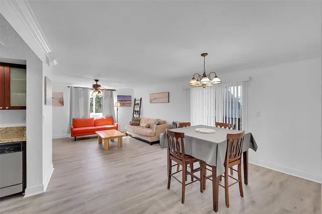 a living room with furniture a window and a chandelier