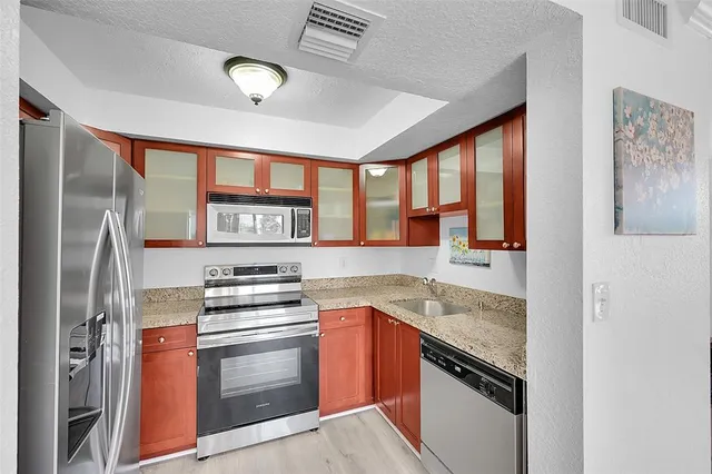 a kitchen with stainless steel appliances granite countertop a stove and a refrigerator