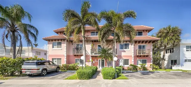 a front view of multiple houses with yard