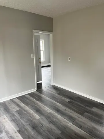 a view of wooden floor and windows in a room