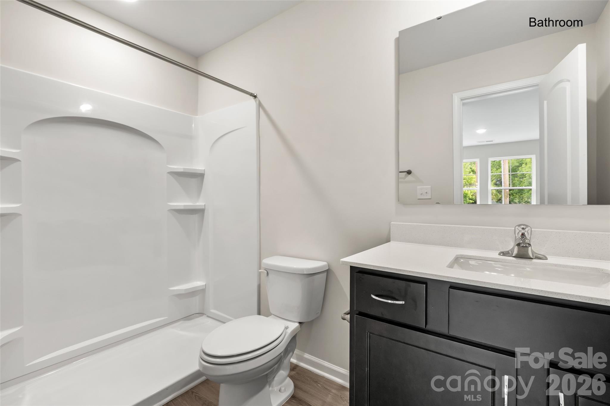 302 Elm Street Lancaster, SC 29720 - Photo 13 of 25 a bathroom with a sink a toilet and a mirror