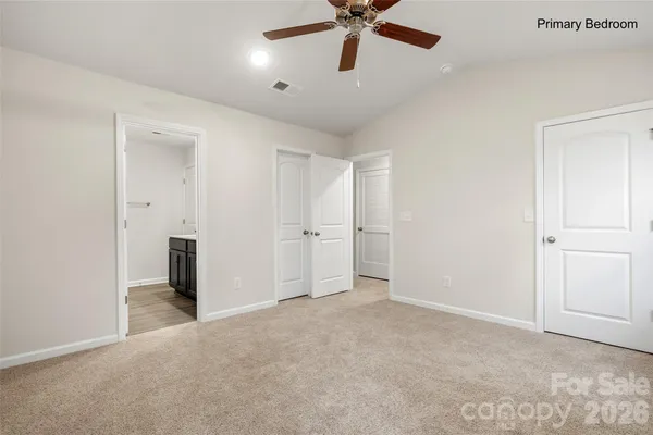 an empty room with a ceiling fan and a window