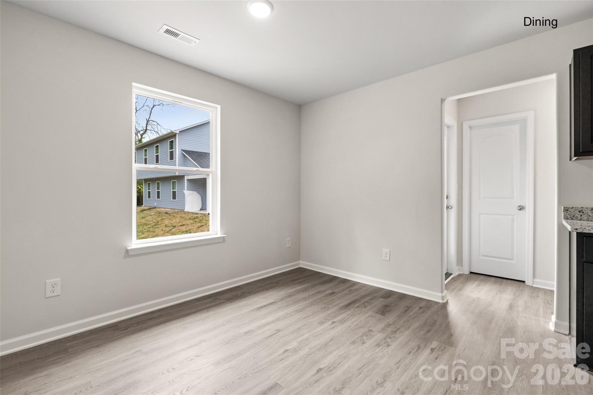 302 Elm Street Lancaster, SC 29720 - Photo 9 of 25 an empty room with wooden floor and windows