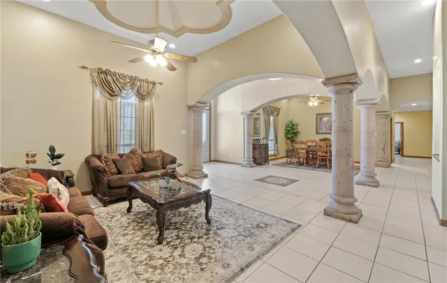 a living room with furniture and a chandelier