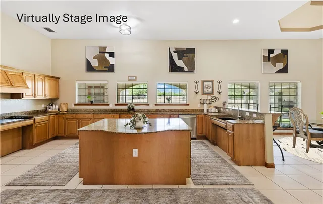 a large kitchen with stainless steel appliances and a counter space