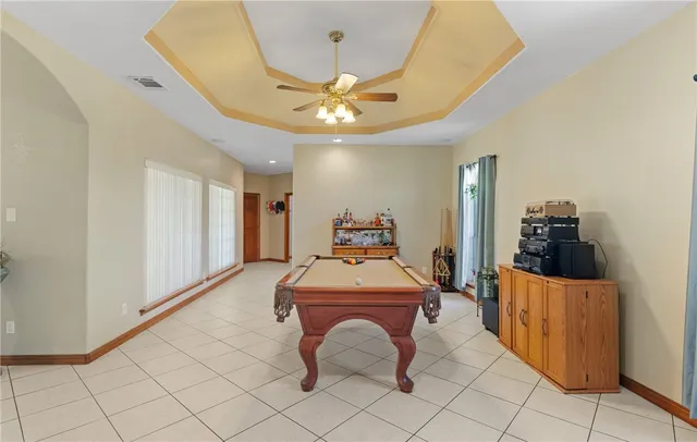 a room with gym equipment and a chandelier