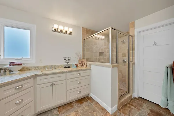 a bathroom with a double vanity sink and mirror