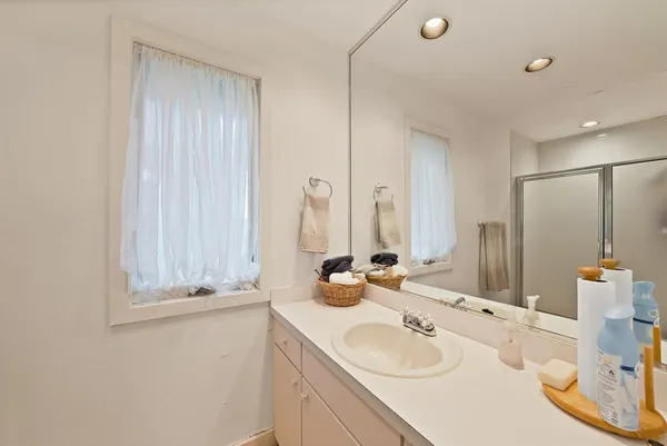 a bathroom with double vanity sink and a mirror