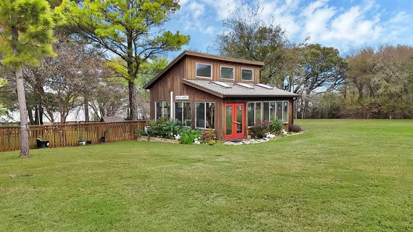 a view of a house with a yard and pathway