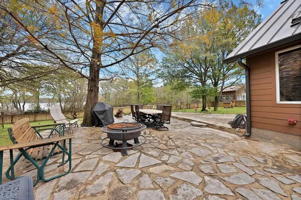 a view of a backyard with sitting area
