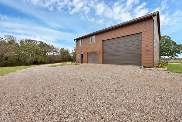 a view of a house with a yard and garage