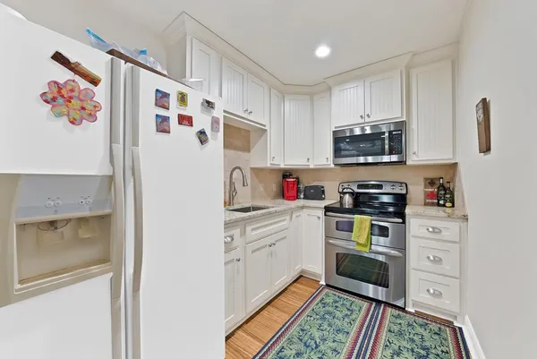 a kitchen with stainless steel appliances a stove a microwave and cabinets