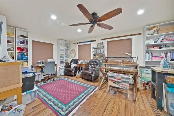 a living room with furniture a rug and a flat screen tv