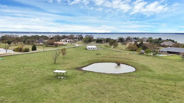 an aerial view of a house with big yard