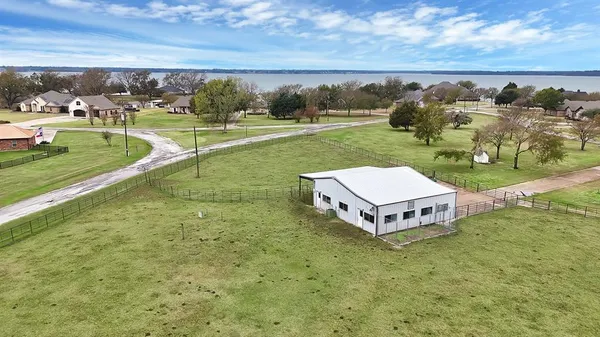 a view of a house with a big yard and potted plants