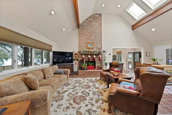 a living room with furniture fireplace and flat screen tv