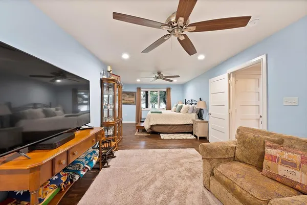 a bedroom with furniture and a large window