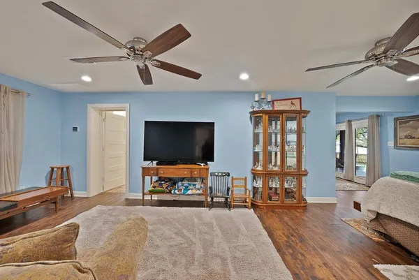 a bedroom with furniture and a flat screen tv