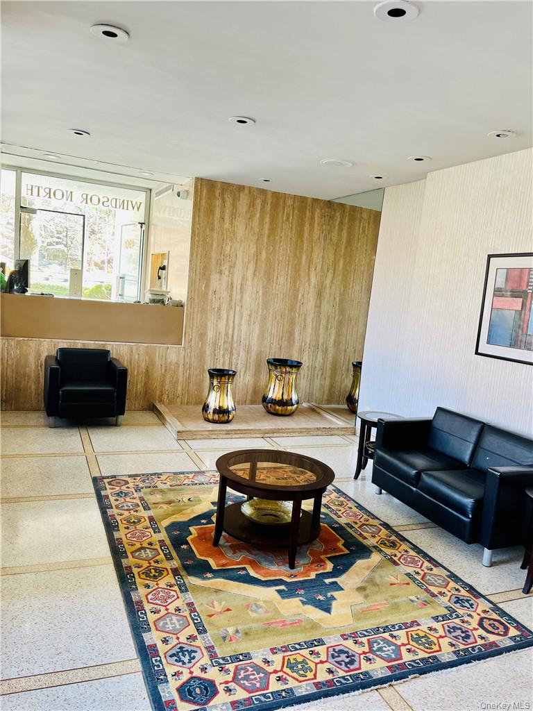4901 Henry Hudson Parkway West, Unit 9F Bronx, NY 10471 - Photo 17 of 17 a living room with furniture and a rug