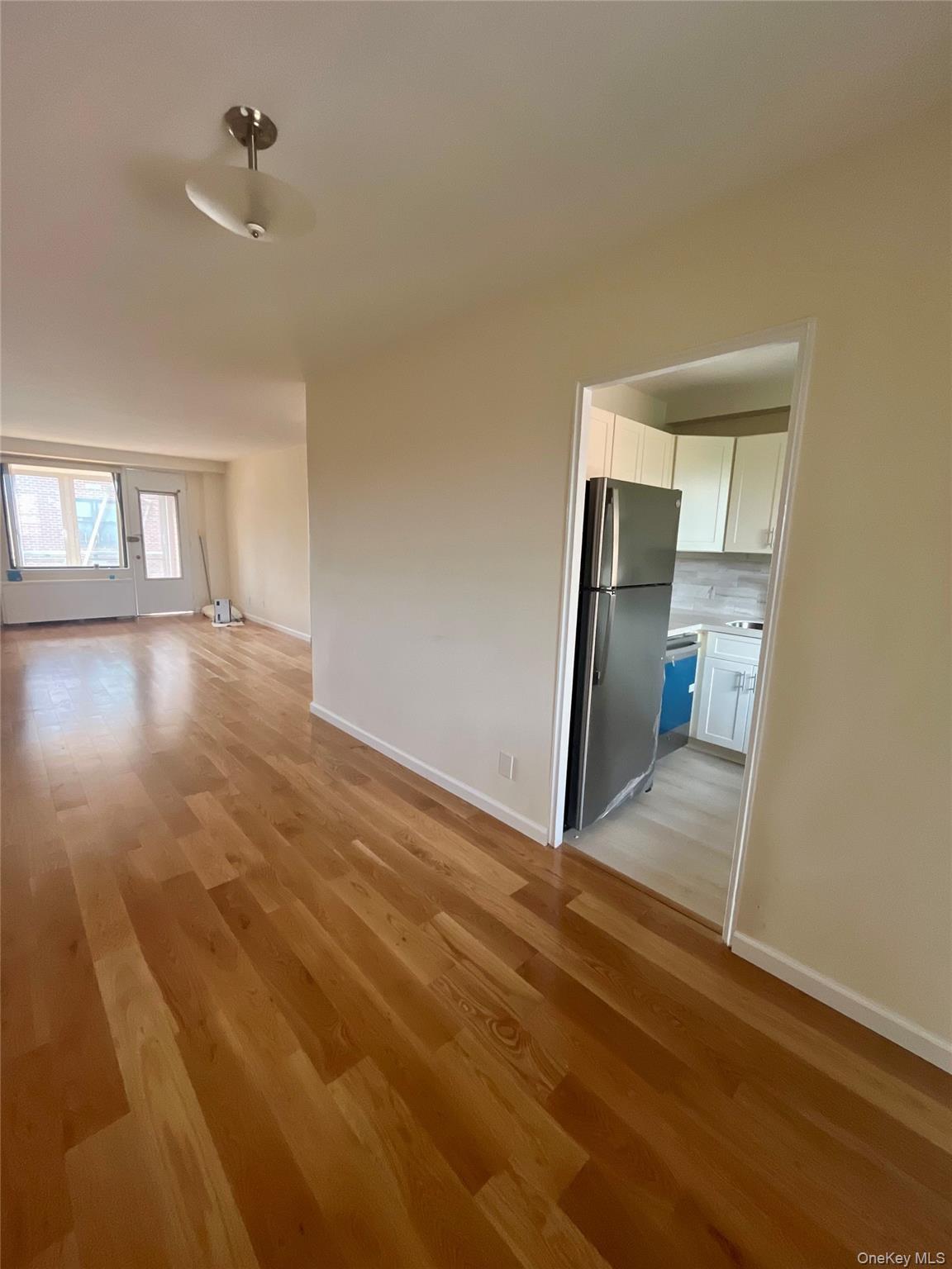 4901 Henry Hudson Parkway West, Unit 9F Bronx, NY 10471 - Photo 6 of 17 a view of a livingroom with wooden floor and a ceiling fan