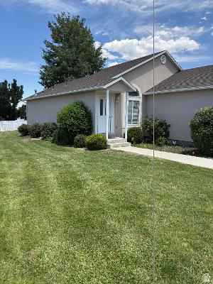 641 East Greystone Way Tooele, UT 84074 - Photo 29 of 30 Stucco exterior with a pitched roof and a gabled entry