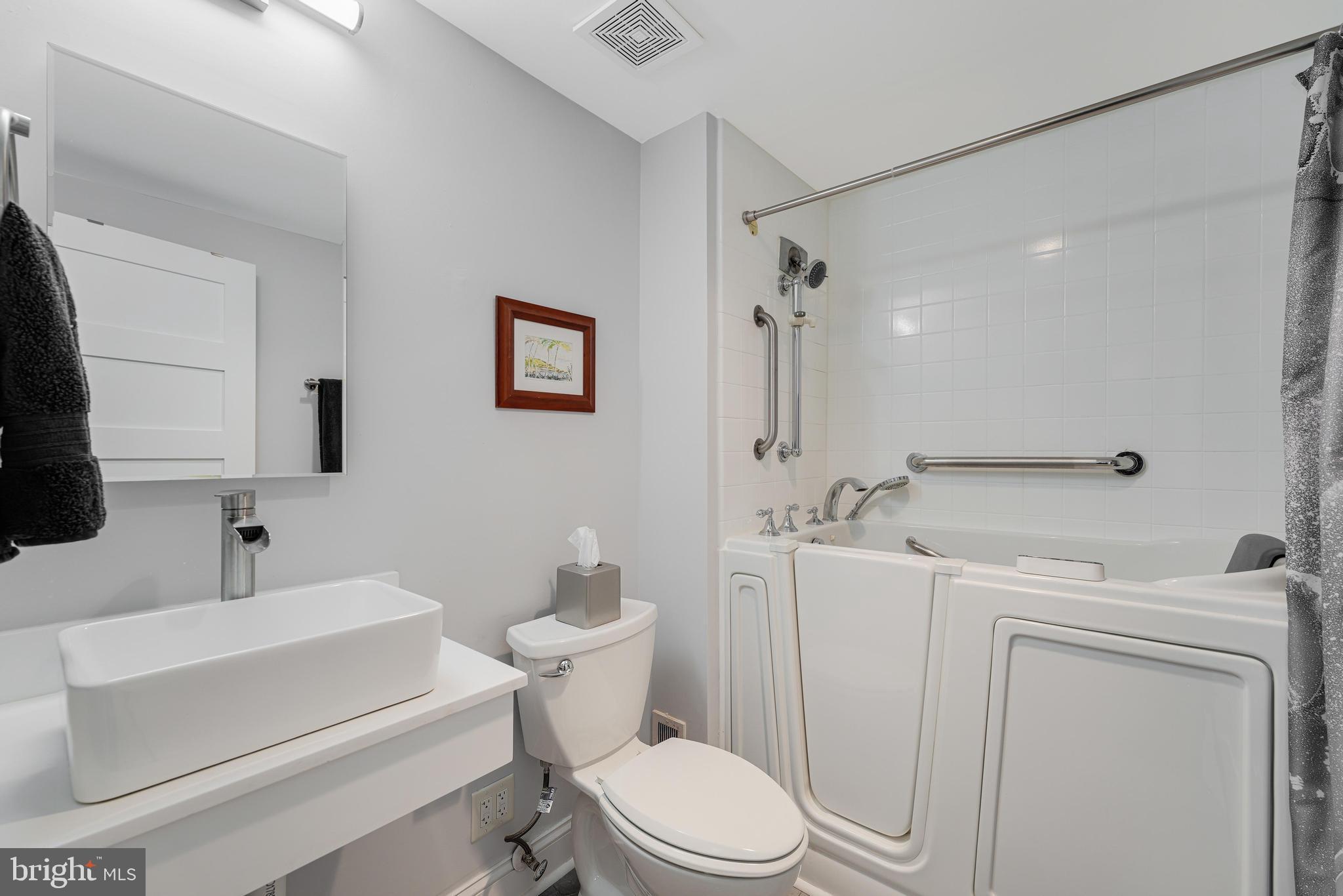 11434 Waterview Cluster Reston, VA 20190 - Photo 34 of 63 a bathroom with a sink a toilet a mirror and shower