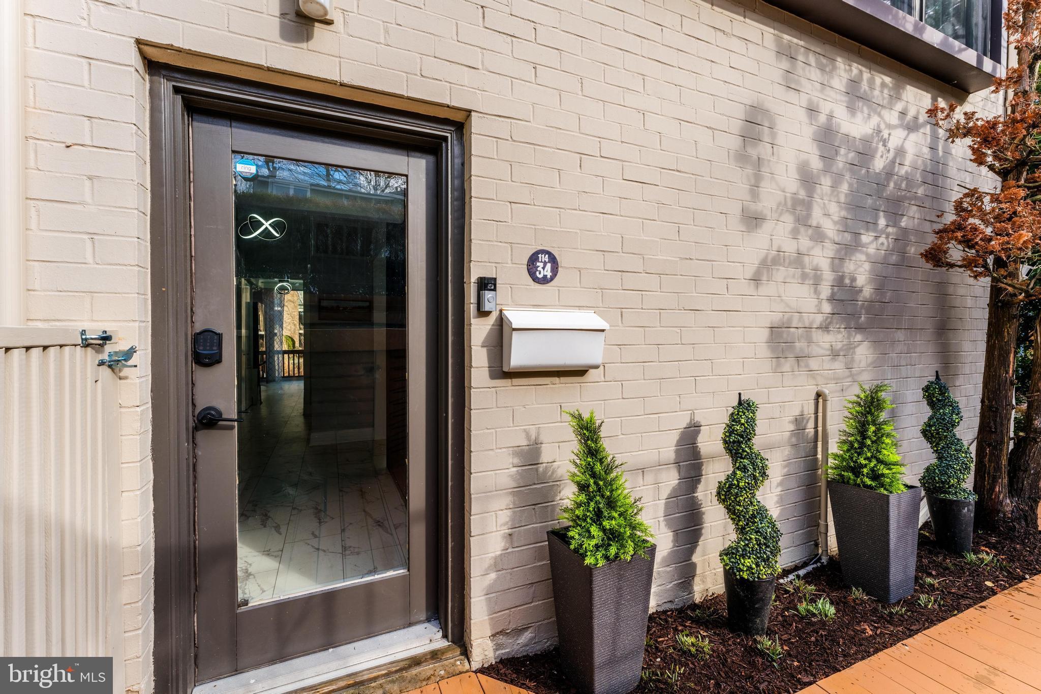 11434 Waterview Cluster Reston, VA 20190 - Photo 5 of 63 a potted plant in front of a door